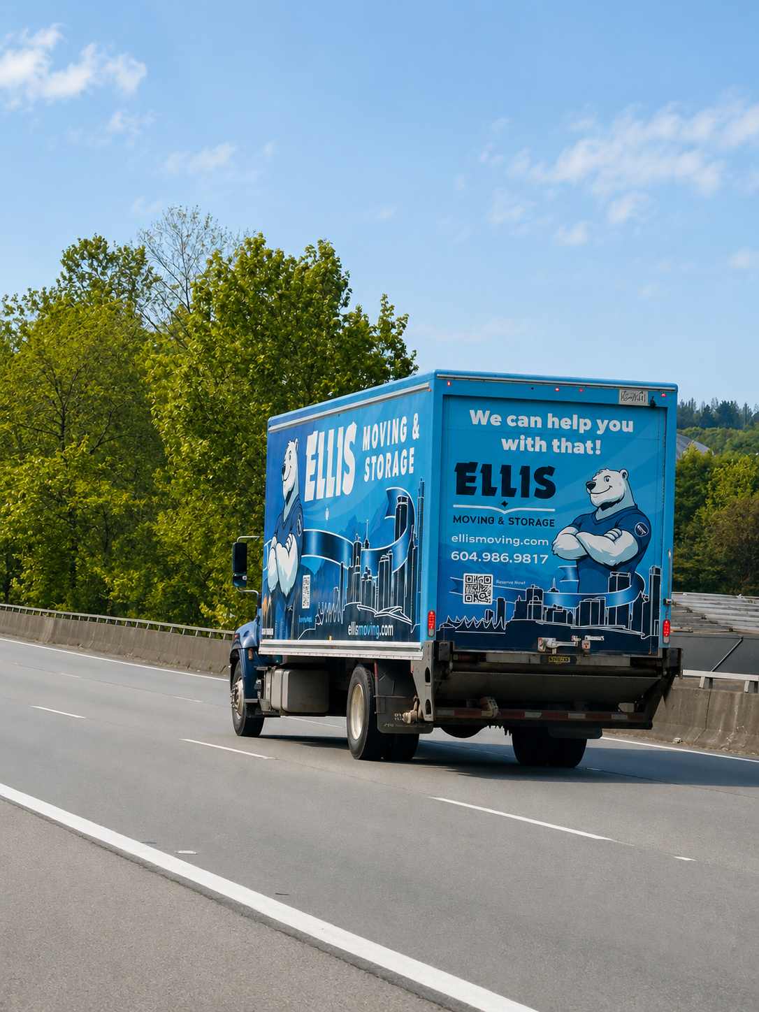 Ellis moving truck crossing the inlet out of North Vancouver at sunset