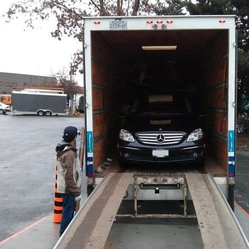 Ellis crew loading an oversize item through a North Vancouver home entryway